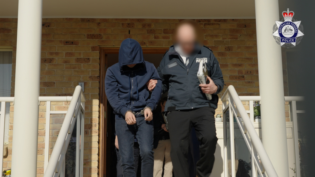 Jung (left) being perp-walked after his arrest in Sydney. Source: AFP